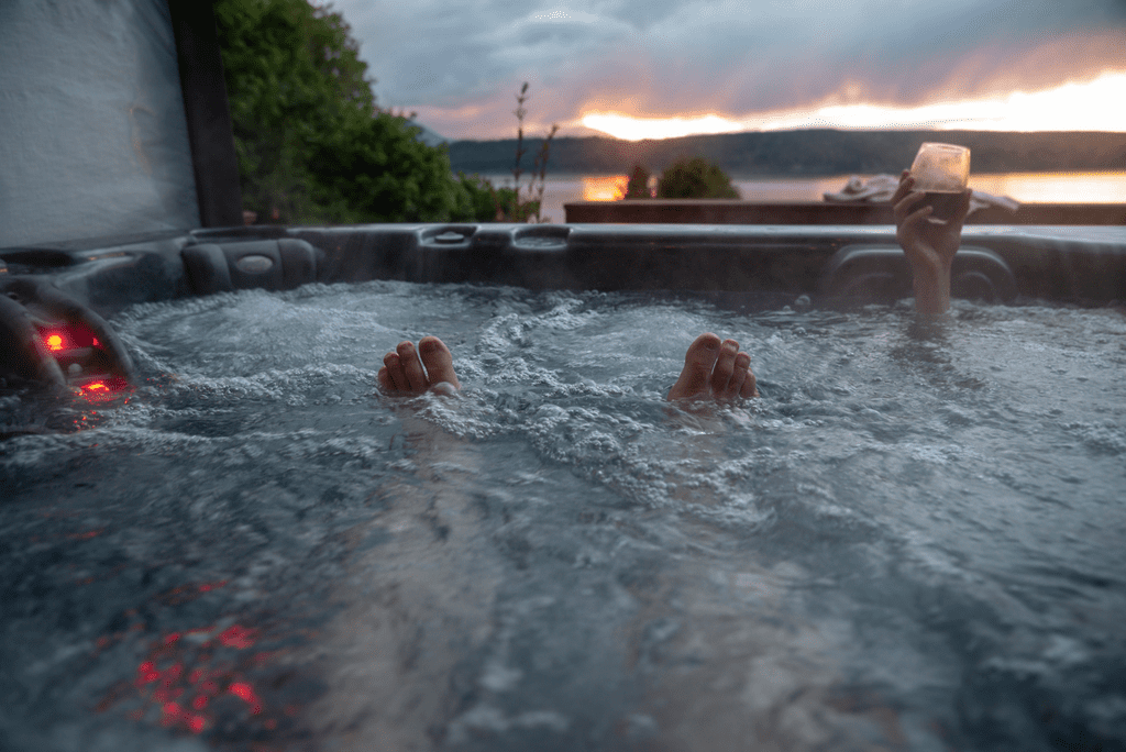 Feet in bubbling hot tub at sunset