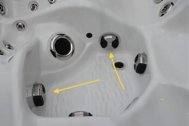 Hot tub footwell showing bypass intake grates affecting filter maintenance
