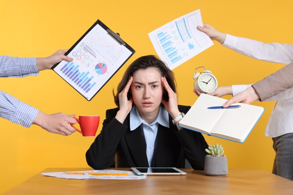 Woman overwhelmed by different requests from colleagues at desk against orange background